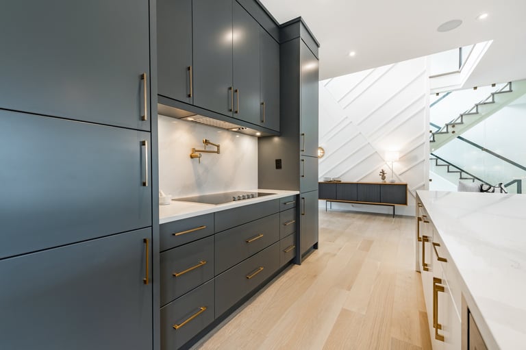 Modern contemporary kitchen with custom cabinetry, large island with bar stools, open to living and dining room