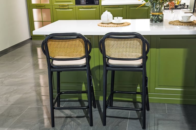 Stylish bar stools complementing a modern kitchen's design with vibrant green cabinetry.